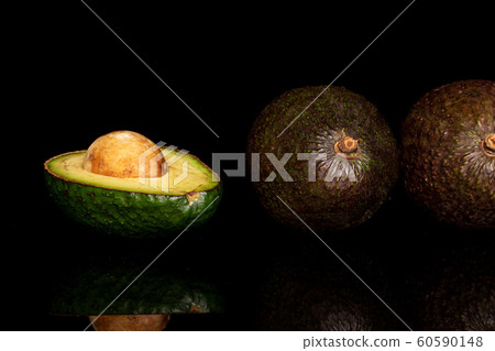 Fresh green avocado isolated on black glass Fresh green avocado isolated on black glass 60590148
