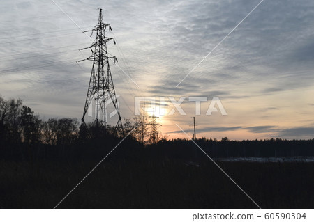 The sun caught on a high-voltage support. 60590304