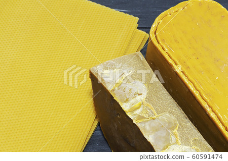 Pieces of natural bees wax. Blocks of yellow wax. 60591474