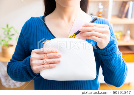 A woman who puts cosmetics in a pouch 60591847