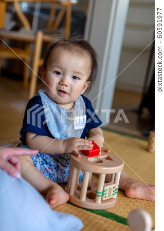 Toddler playing alone 60591977