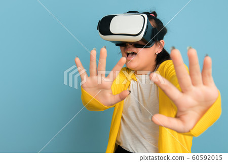 Asian teenager's portrait isolated on blue studio background 60592015