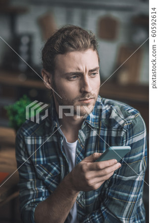 Man feeling disappointed with the message he received 60592614