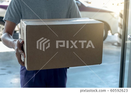 Young delivery man handling parcels order.Shipment and logistic in e-commerce industry deliver by postman. Young delivery man handling parcels order.Shipment and logistic in e-commerce industry deliver by postman. 60592623
