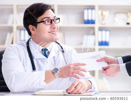 Young doctor in medical insurance fraud concept Young doctor in medical insurance fraud concept 60593611