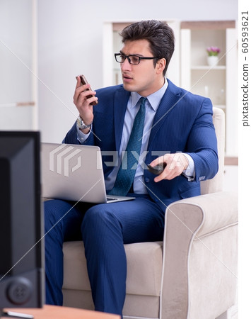 Businessman watching tv in the office 60593621