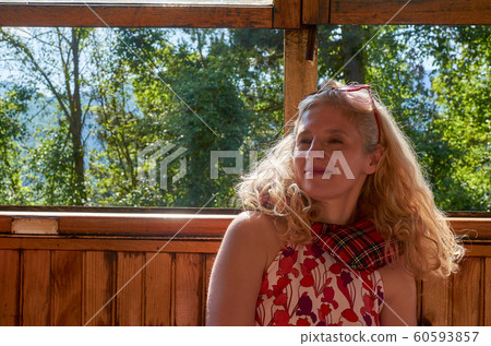 Woman sitting in a vintage train Woman sitting in a vintage train 60593857