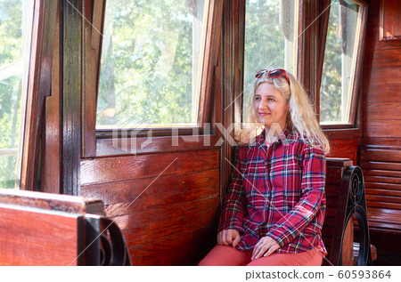 Sitting in a vintage train 60593864