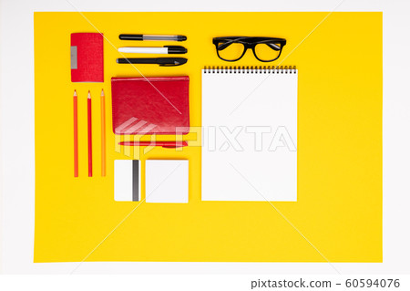 School and office supplies lie neatly on a yellow background 60594076