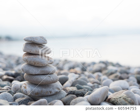 Pyramid of smooth stones on the beach Pyramid of smooth stones on the beach 60594755