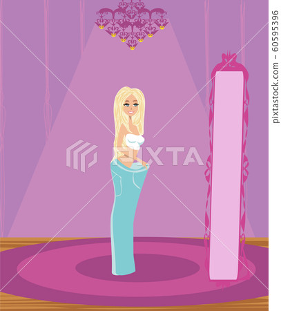 Beautiful woman looking at her waistline in mirror 60595396