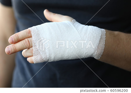Male hand with tight elastic bandage on arm closeup 60596200