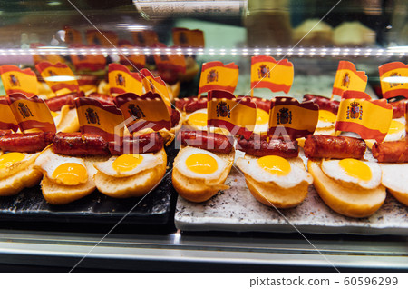 Spanish burger with omelet and souvenir flag of Spain in the market of San Miguel Spanish burger with omelet and souvenir flag of Spain in the market of San Miguel 60596299
