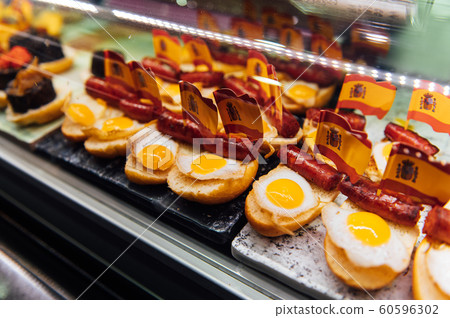 Spanish burger with omelet and souvenir flag of Spain in the market of San Miguel 60596302