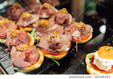 A wide variety of traditional tapas with seafood in Spain at the San Miguel market A wide variety of traditional tapas with seafood in Spain at the San Miguel market 60596305