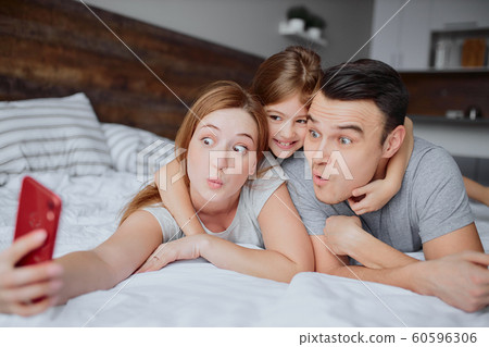 funny family with child on bed funny family with child on bed 60596306