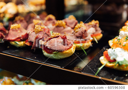 A wide variety of traditional tapas with seafood in Spain at the San Miguel market A wide variety of traditional tapas with seafood in Spain at the San Miguel market 60596308