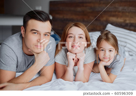 friendly caucasian family on bed friendly caucasian family on bed 60596309