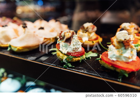 A wide variety of traditional tapas with seafood in Spain at the San Miguel market A wide variety of traditional tapas with seafood in Spain at the San Miguel market 60596310
