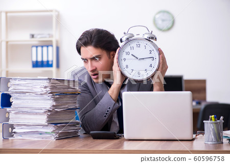 Young male employee unhappy with excessive work 60596758