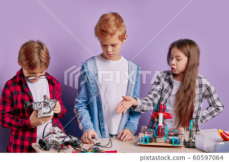 enthusiastic concerned children assembling tech robots, future engineers enthusiastic concerned children assembling tech robots, future engineers 60597064