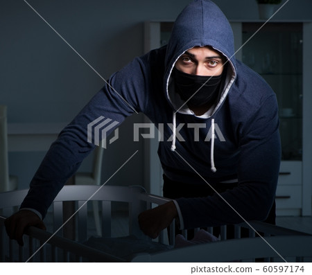 The criminal stealing baby in human child traficking concept The criminal stealing baby in human child traficking concept 60597174