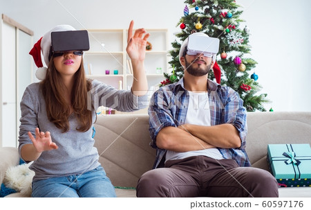 Happy family using virtual reality VR glasses during christmas Happy family using virtual reality VR glasses during christmas 60597176