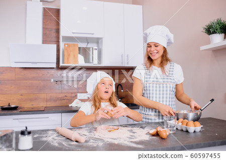funny mother and child together in kitchen funny mother and child together in kitchen 60597455