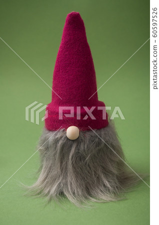 Closeup of christmas gnome on green background 60597526
