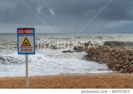 Sign on the beach, no lifeguard protection. Storm in Portugal. 60597857