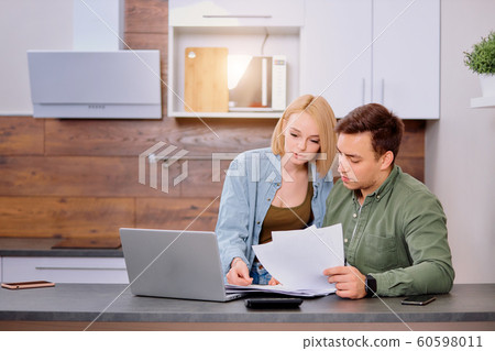 young man and awoman working with new startup project at home young man and awoman working with new startup project at home 60598011