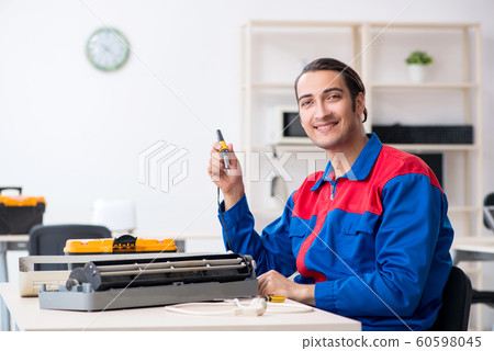 Young repairman repairing air-conditioner at warranty center 60598045
