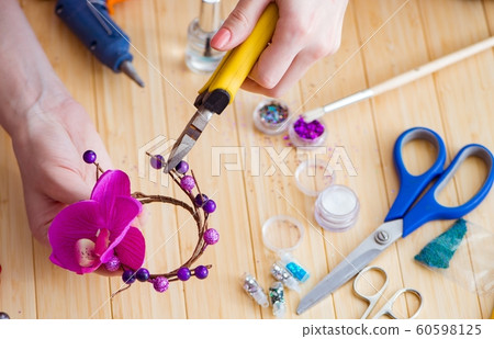 Woman making jewelry at home Woman making jewelry at home 60598125