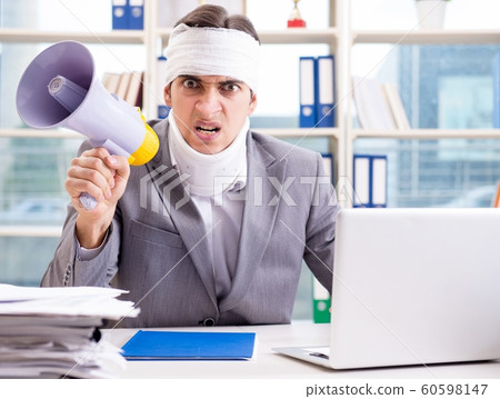 Injured businessman working in the office Injured businessman working in the office 60598147