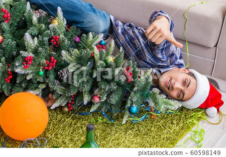 Man having hangover after christmas party Man having hangover after christmas party 60598149