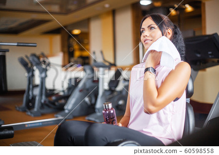 Fitness girl workout in the gym. Exercises for women, bodybuilder train, sports lifestyle Fitness girl workout in the gym. Exercises for women, bodybuilder train, sports lifestyle 60598558