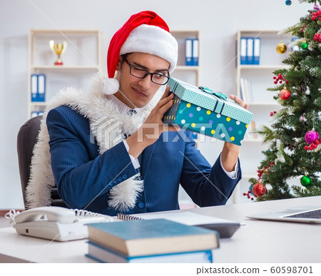 Businessman celebrating christmas holiday in the office Businessman celebrating christmas holiday in the office 60598701
