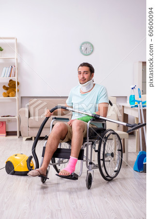 Young man in wheel-chair cleaning the house Young man in wheel-chair cleaning the house 60600094