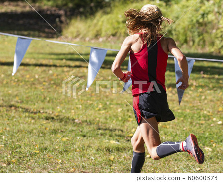 Rear view of leader of 5K cross country race on Rear view of leader of 5K cross country race on 60600373