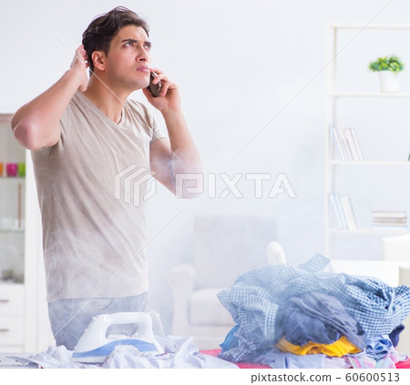 Inattentive husband burning clothing while ironing 60600513
