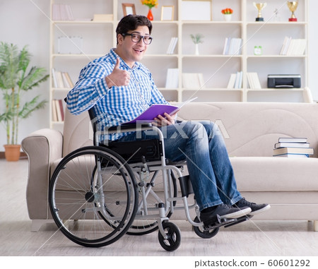 Young student on wheelchair in disability concept Young student on wheelchair in disability concept 60601292