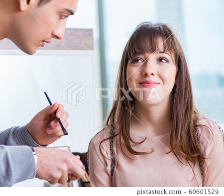 The man doing make-up for cute woman in beauty salon The man doing make-up for cute woman in beauty salon 60601529