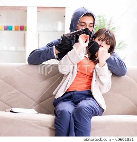 Armed man assaulting young woman at home 60601851