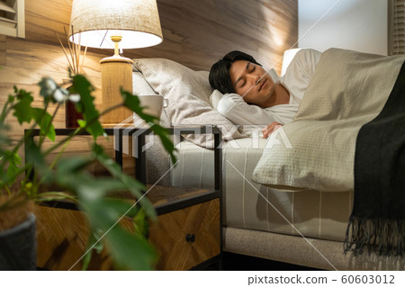 Young man sleeping bedroom lifestyle image Young man sleeping bedroom lifestyle image 60603012