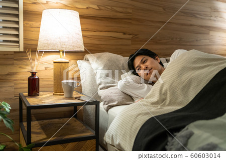Young man sleeping bedroom lifestyle image Young man sleeping bedroom lifestyle image 60603014