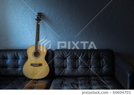 Guitar folk on the sofa with beautiful light in the night time Guitar folk on the sofa with beautiful light in the night time 60604703