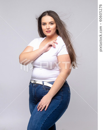 Plus Size Model with long hair posing in studio 60605276