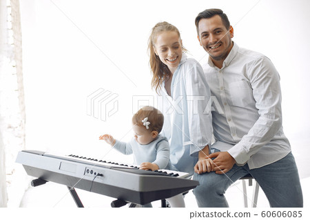 Beautiful family spend time in a music studio 60606085