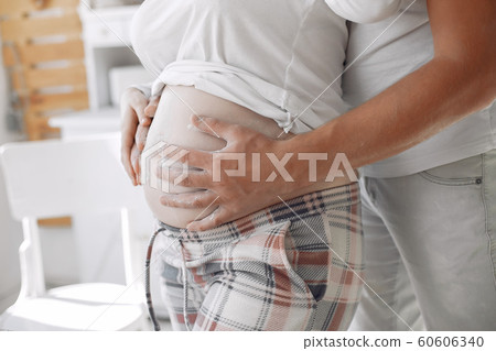 Beautiful couple spend time in a kitchen Beautiful couple spend time in a kitchen 60606340