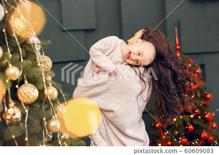 Mother with cute daughter near christmas tree Mother with cute daughter near christmas tree 60609083